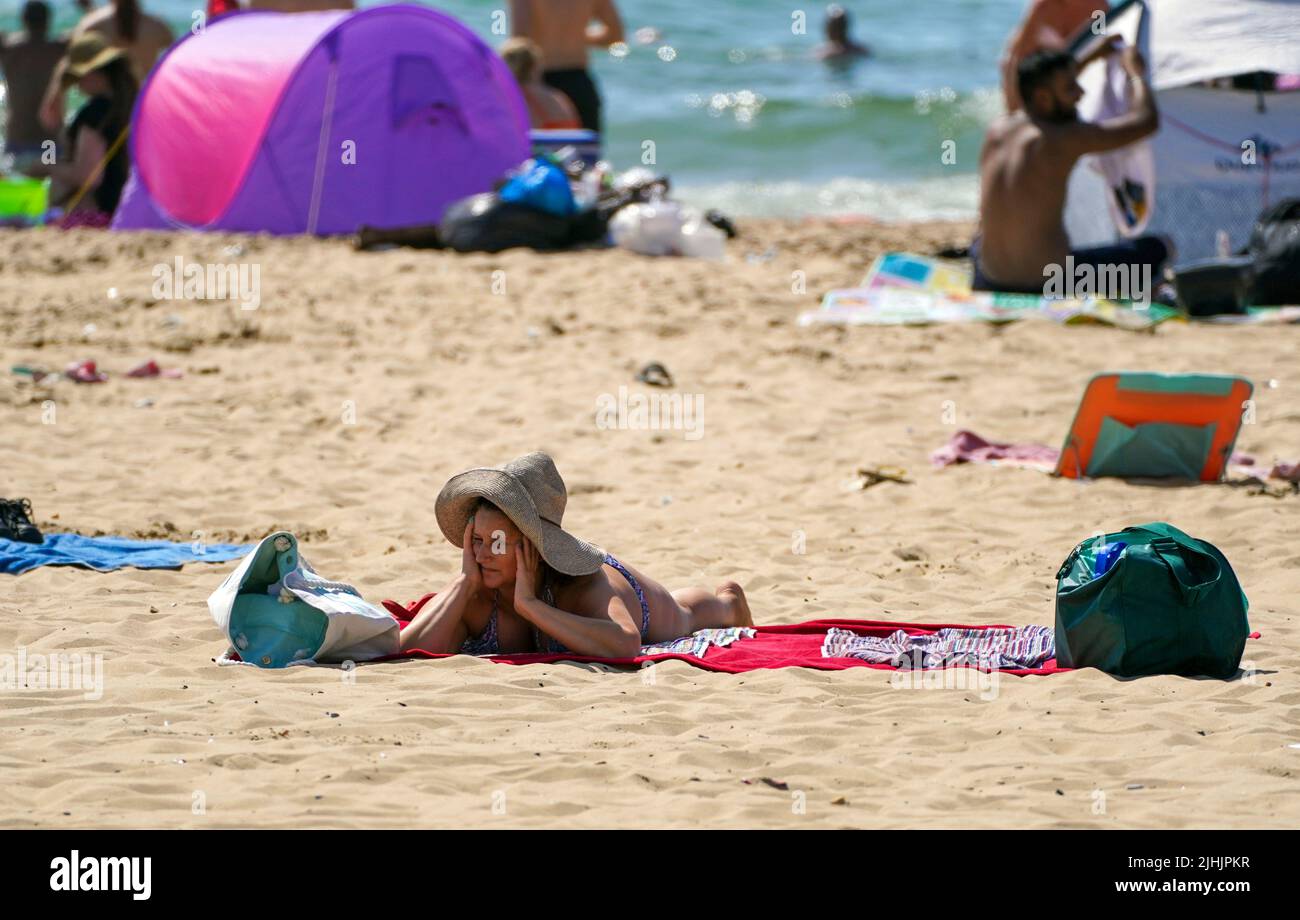 Une dame se pose sur la plage de Bournemouth. Les Britanniques sont sur le point de fondre le jour le plus chaud jamais enregistré au Royaume-Uni alors que les températures devraient atteindre 40C. Date de la photo: Mardi 19 juillet 2022. Banque D'Images