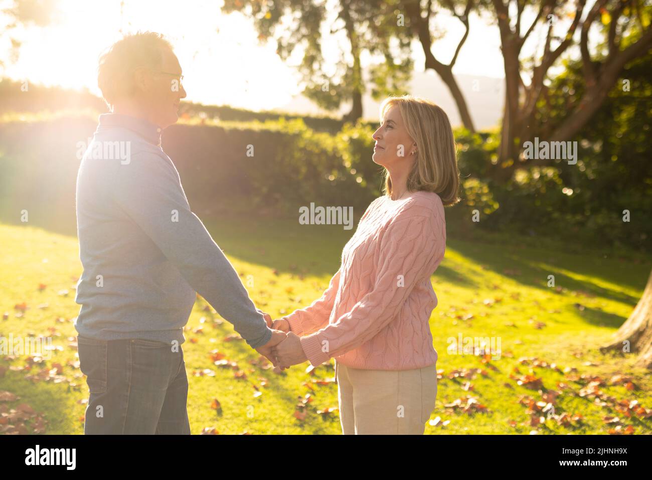 Image d'un couple caucasien âgé heureux tenant les mains dans le jardin Banque D'Images