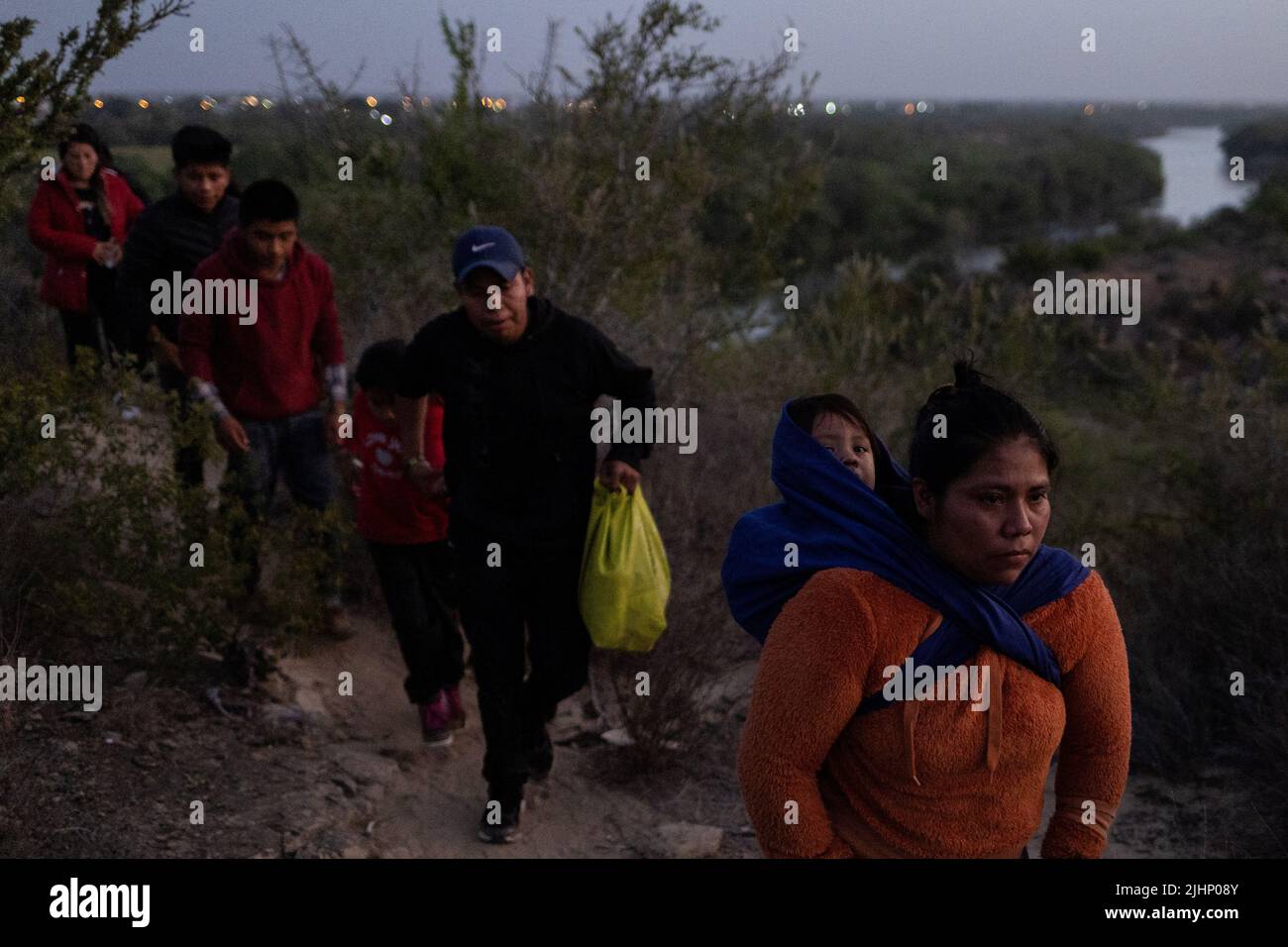 Des migrants d'Amérique centrale et d'Amérique du Sud marchent le long d'un sentier de terre après avoir traversé le fleuve Rio Grande aux États-Unis depuis le Mexique, à Rome, Texas, États-Unis, 16 juillet, 2022. REUTERS/Adrees Latif Banque D'Images
