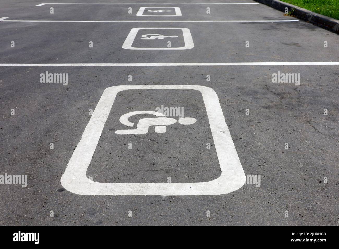 Panneaux de signalisation pour les parkings handicapés dans la rue. Place de parking pour handicapés, signe de fauteuil roulant peint sur l'asphalte Banque D'Images