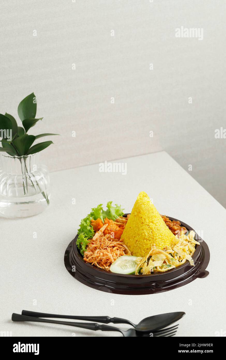 Nasi Tumpeng Mini Agustusan est un riz jaune en forme de dôme avec divers accompagnement pour célébrer le jour de l'indépendance indonésienne Banque D'Images