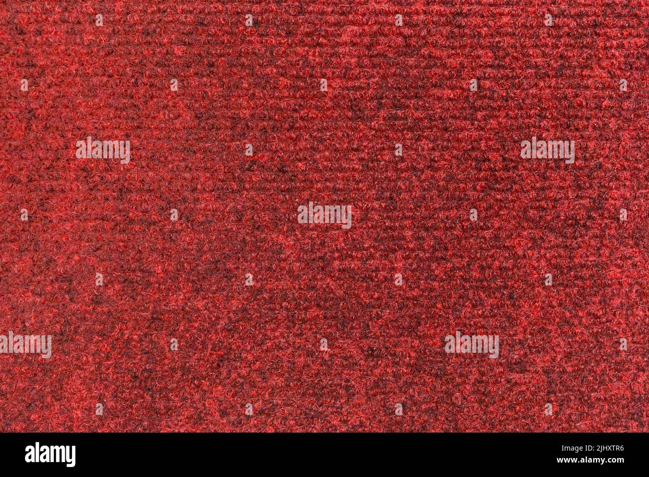 Tissu de tapis texture rouge textile motif matière surface sol souple arrière-plan abstrait. Banque D'Images