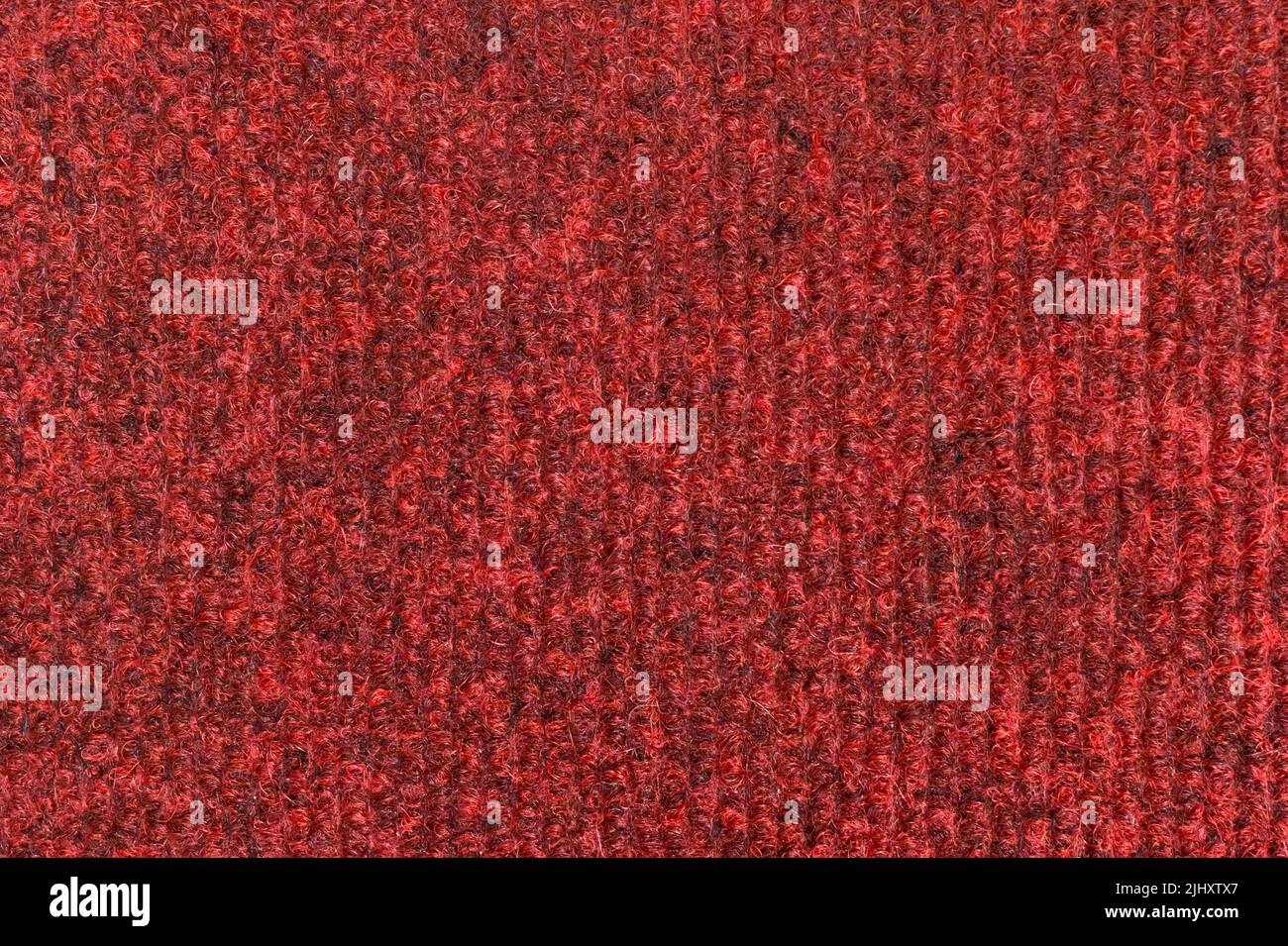 Tissu de tapis texture rouge textile motif matière surface sol souple arrière-plan abstrait. Banque D'Images