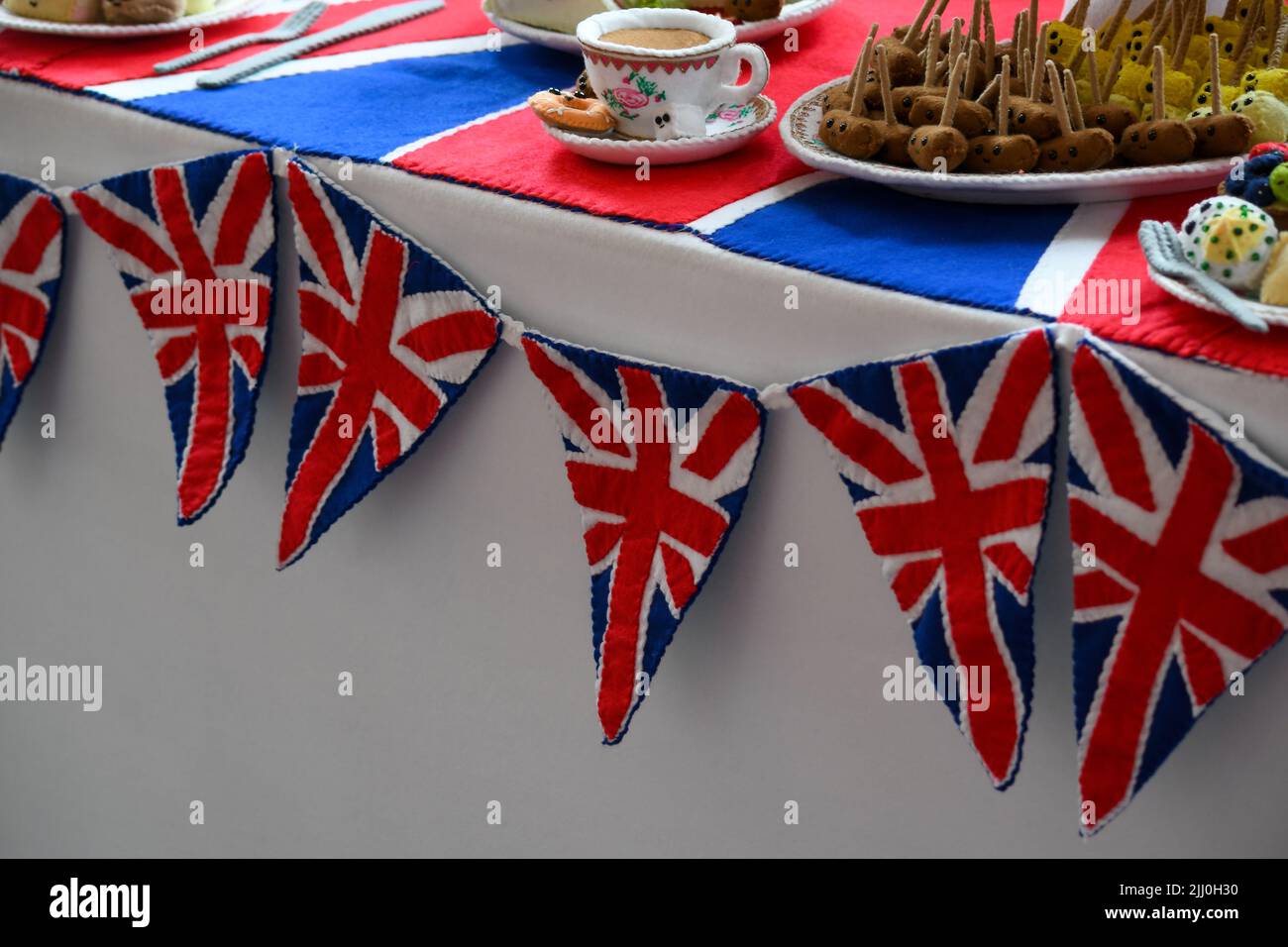 Londres, Royaume-Uni, 22nd juillet 2022, les salles d'état de Buckingham Palace ont rouvert après trois ans. Il s'agit maintenant d'une exposition spéciale du Jubilé de platine des bijoux de la Reine dans laquelle elle a été photographiée pendant les soixante-dix années de son règne. Il y a aussi des photographies de la photographe royale Dorothy Wilding. Les photographies sont assorties avec les bijoux que la Reine portait dans les images. Au début de la visite, vous pouvez également voir un déjeuner du Jubilé de platine créé à partir de feutre. Lucy Sparrow l'a conçu. Ouvert jusqu'au 2nd octobre 2022. , Andrew Lalchan Photography/Alamy Live News Banque D'Images