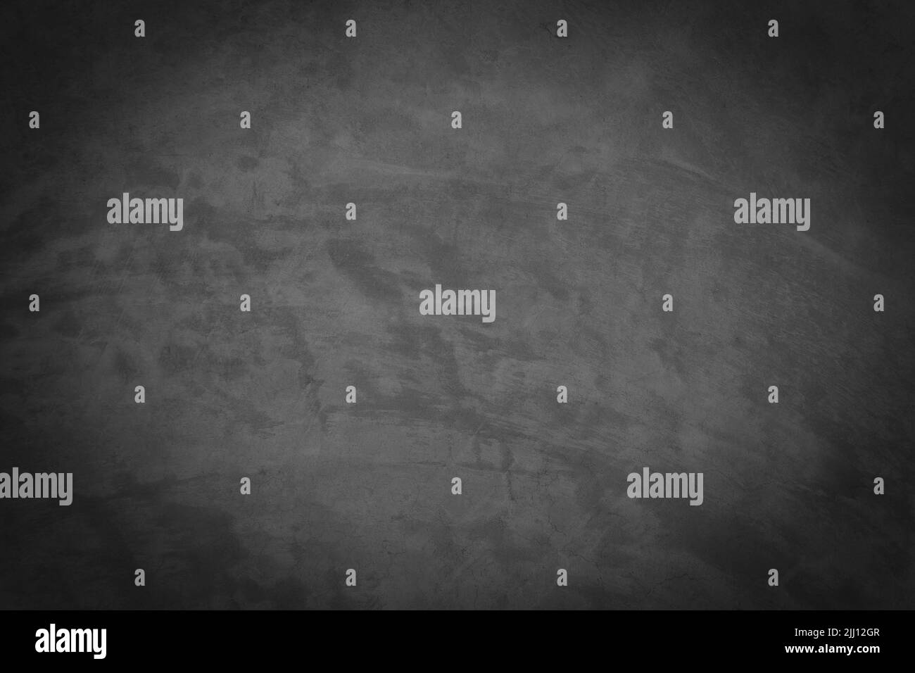 Vieux mur de ciment gris avec des fissures sur la surface. Banque D'Images