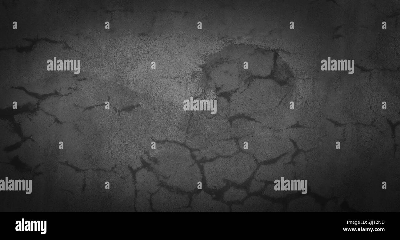 Vieux mur de ciment gris avec des fissures sur la surface. Banque D'Images