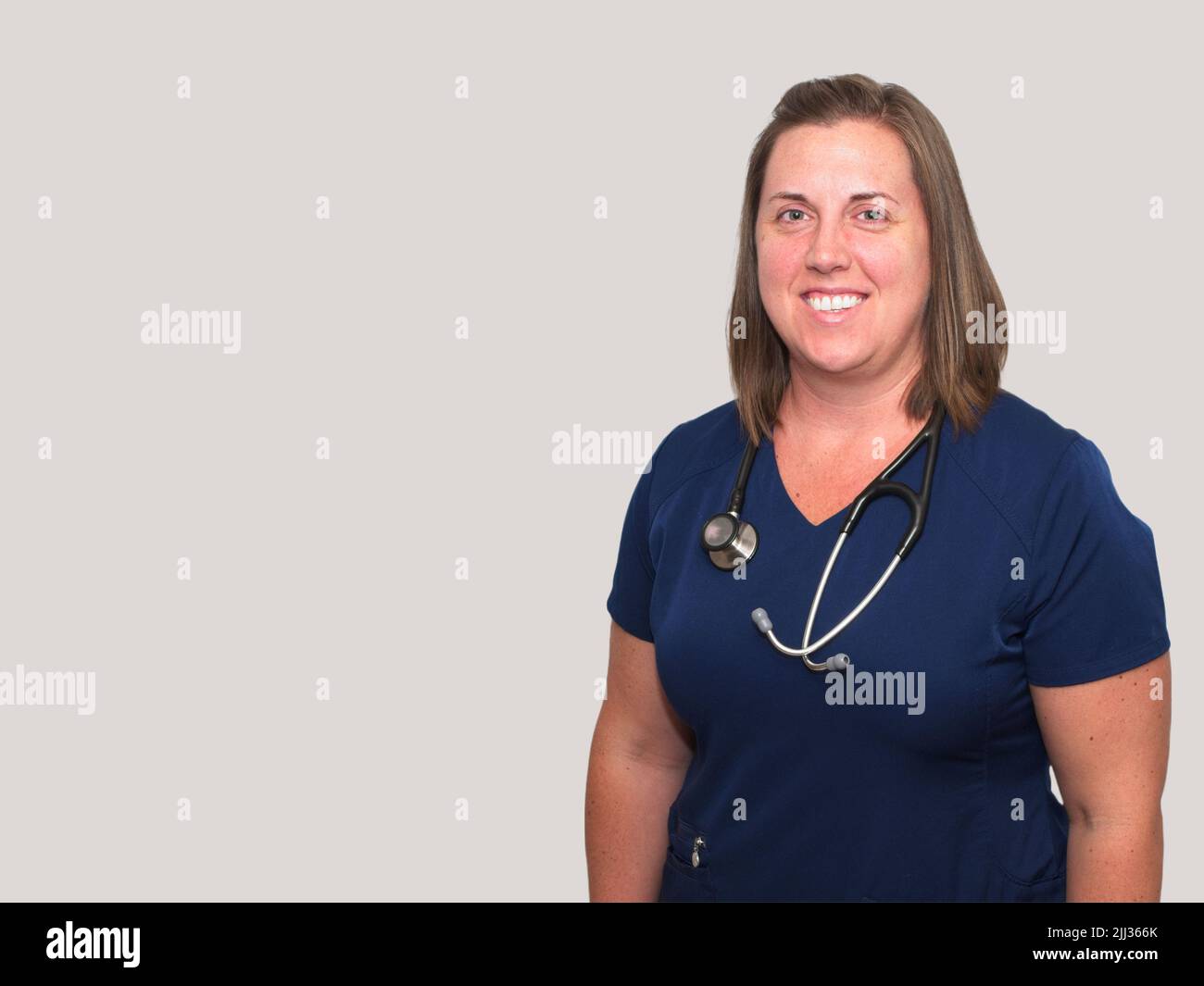La profession médicale n'est pas facile, mais elle est certainement gratifiante pour cette infirmière praticienne souriante. Banque D'Images