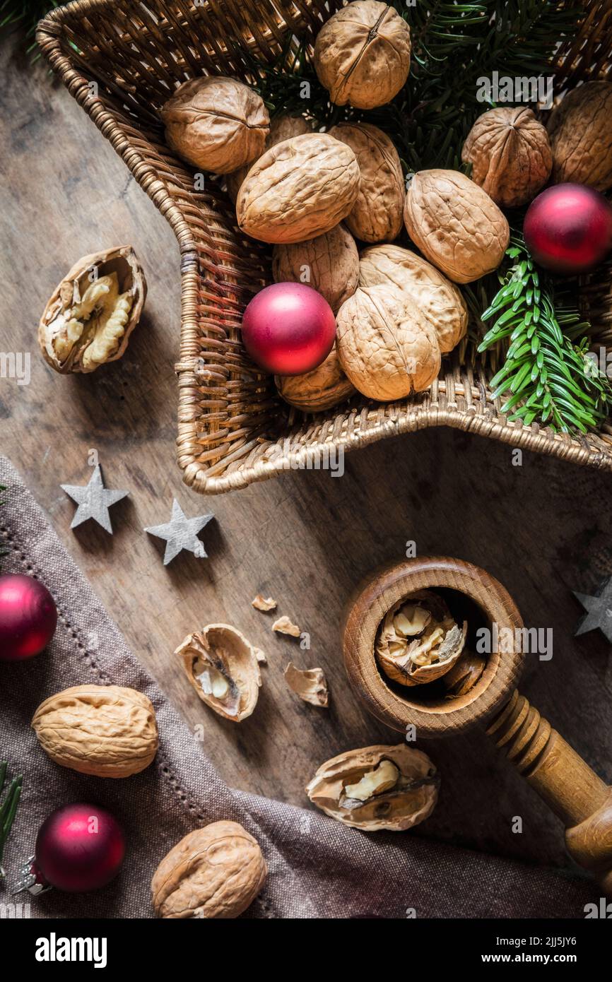 Photo de studio de planche à découper, panier en osier en forme d'étoile, décorations de Noël, noix et casse-noisettes simples Banque D'Images