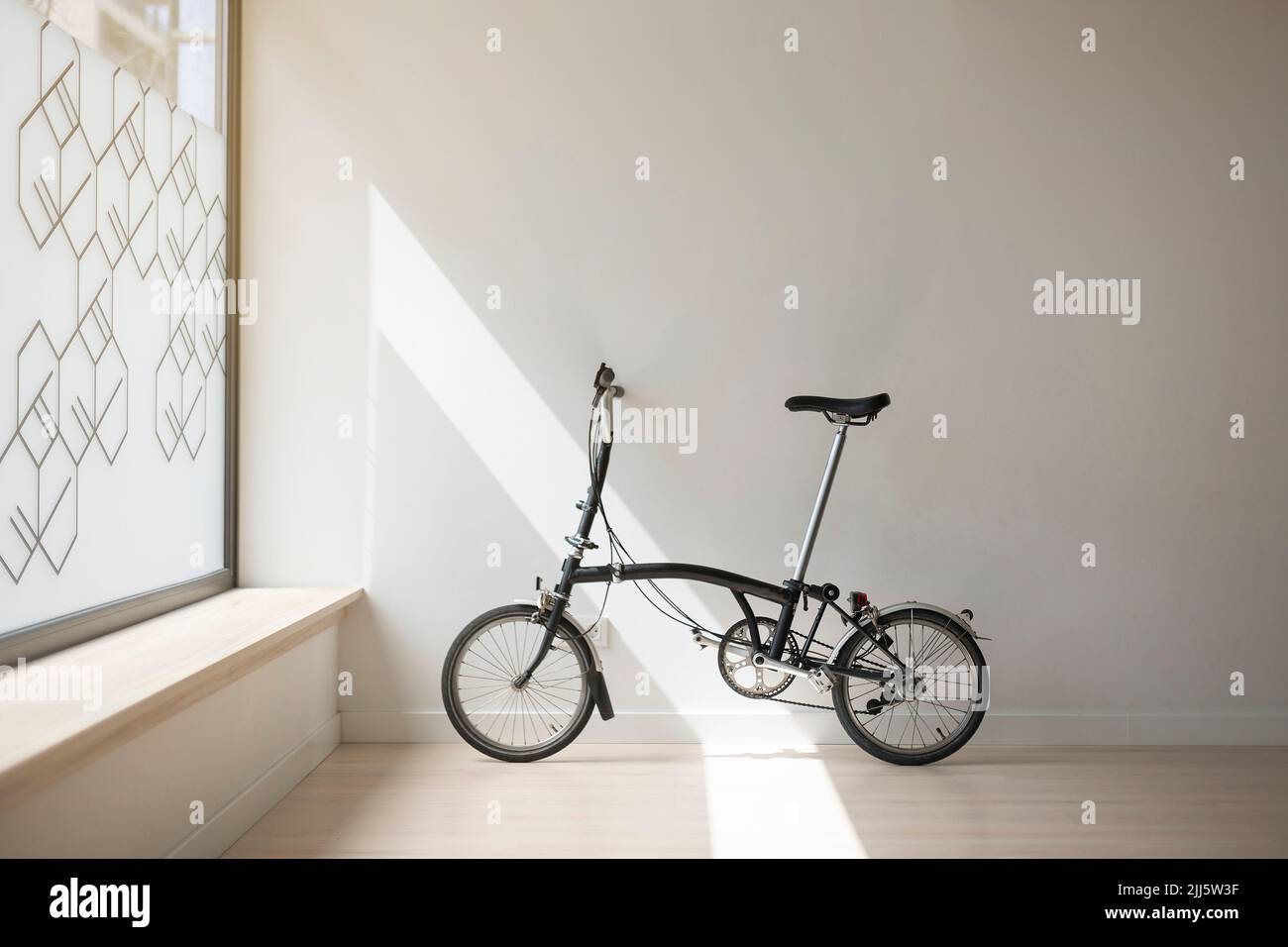 Vélo appuyé sur le mur blanc dans le studio de yoga Banque D'Images