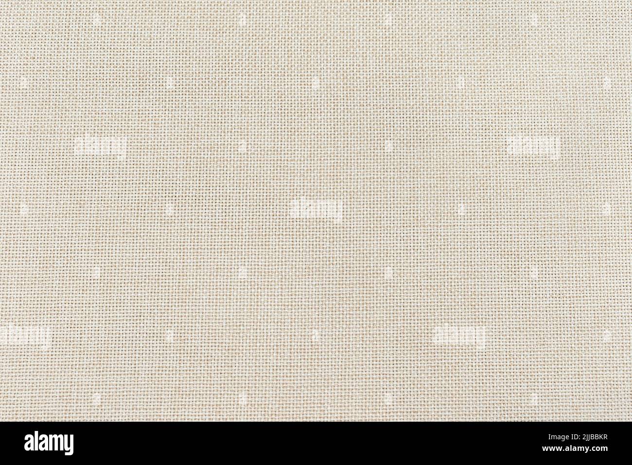 macro-gros plan d'un linge beige clair et étroitement tissé comme un tissu présentant un motif et une texture détaillés Banque D'Images