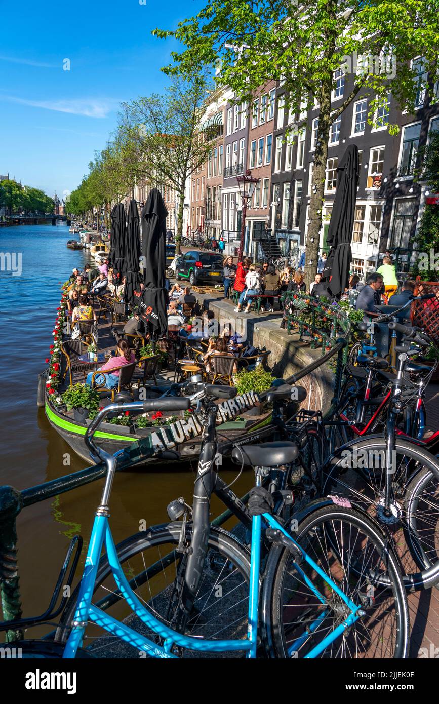 Maisons sur le canal Kloveniersburgwal, la vieille ville d'Amsterdam, Canal Belt, Aluminiumbrug, café avec terrasse sur un bateau à ponton, Amsterdam, pays-Bas Banque D'Images