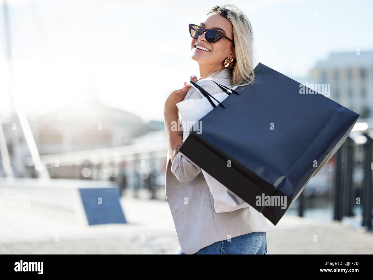 La joie naît de l'intérieur. Une jeune femme qui profite d'une journée de shopping. Banque D'Images