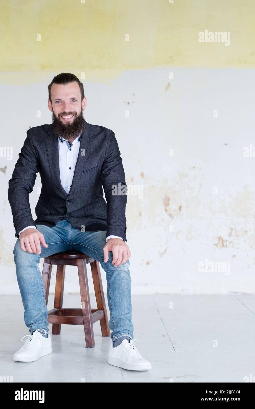 homme d'affaires portrait élégant souriant mur assis Banque D'Images