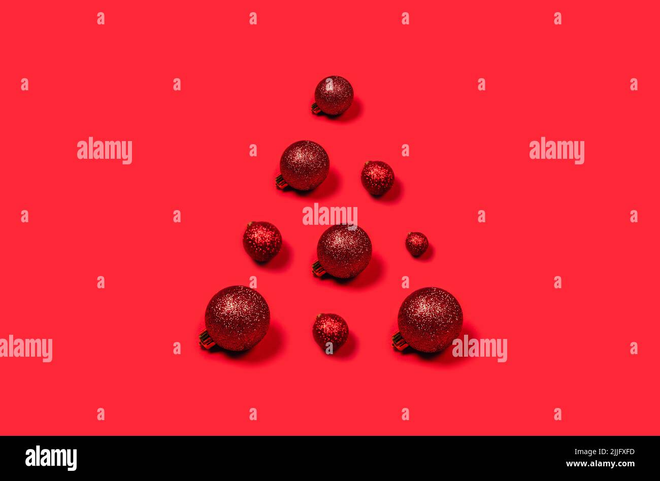 Volume Noël composition de boules rouges de Noël disposés sous forme de triangle sur fond clair. Banque D'Images