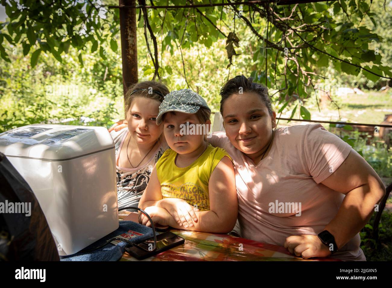 Zalta, la candidate de l'équipe nationale de l'Ukraine aux Jeux paralympiques pose pour une photo avec ses sœurs Zalta, Sana car elles vivent maintenant dans une maison sans électricité, eau et gaz avec 5 chats, 3 chiens, canards et poulets à Slovyansk, Donbas. Bien que l'avance russe se rapproche de plus en plus, certains des citoyens de Slovyansk ont décidé, pour diverses raisons, de rester à la traîne. Slovyansk avec une population de 106 972 (2021 est.), est maintenant une ville stratégique principale dans la région de Donetsk, comme la ville a été continuellement bombardée par des artilleries russes et de manquer Banque D'Images