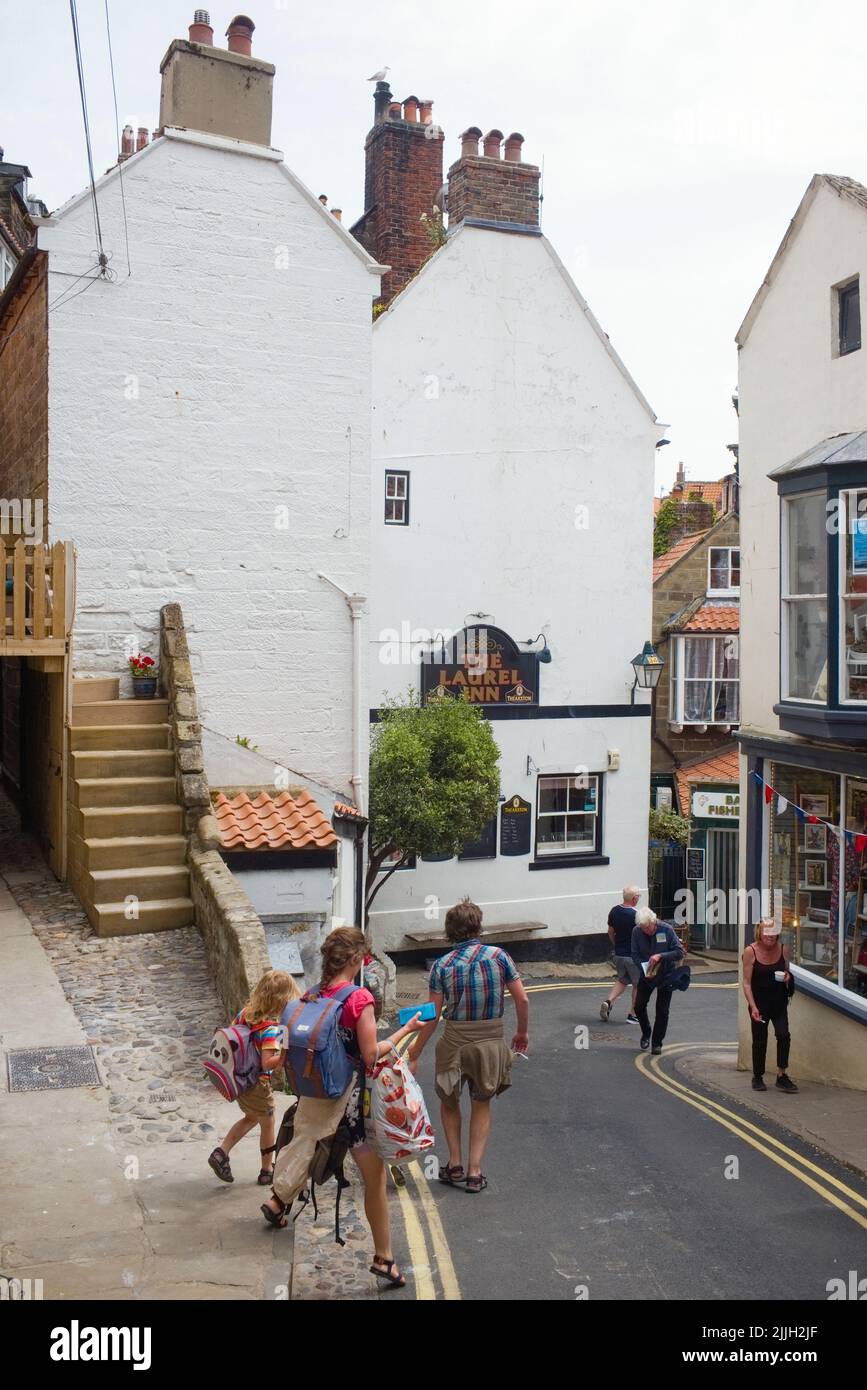 Le Laurel inn à Robin Hood's Bay avec des gens qui descendent jusqu'à la plage Banque D'Images