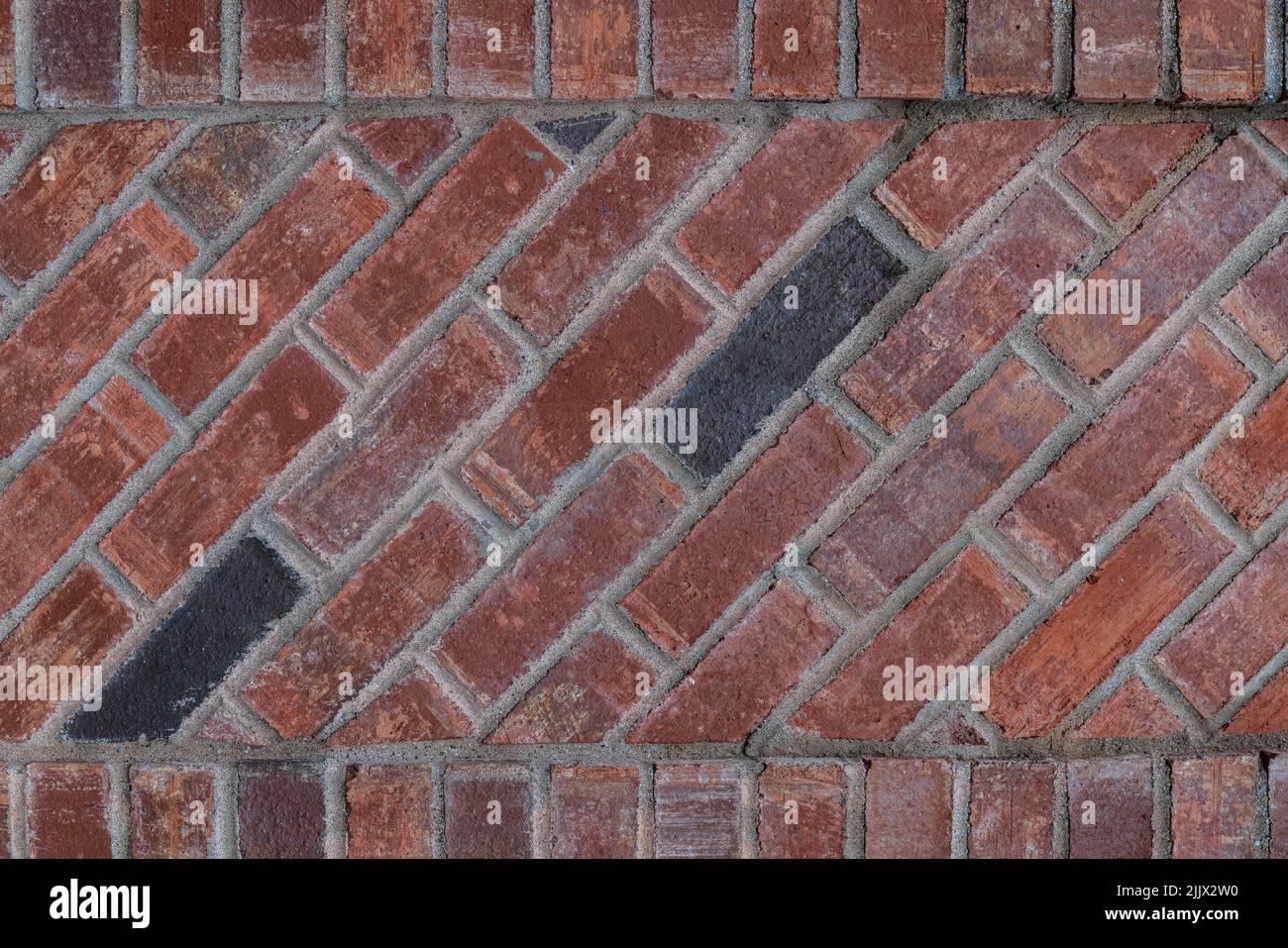 Un mur de briques avec un arrière-plan de texture de collage diagonal Banque D'Images