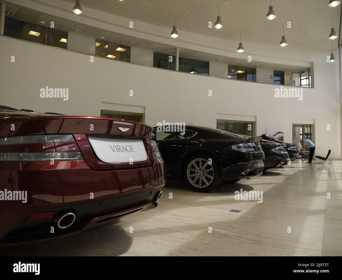 Aston Booty: Les extrémités arrière de quatre Aston Martins garés dans l'atrium client du siège de AM à Gaydon, Warwickshire Banque D'Images
