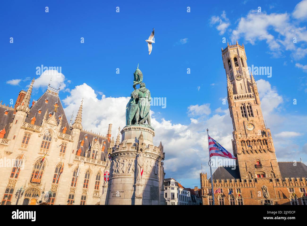 Pigeon survolant la place du marché de Bruges, architecture flamande Banque D'Images
