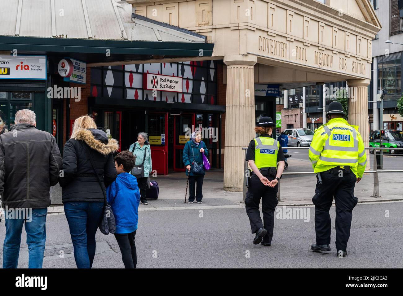 Deux policiers patrouillent à la gare routière de Pool Meadow, Coventry, West Midlands, Royaume-Uni. Banque D'Images