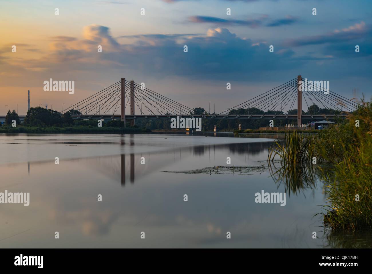 Wroclaw, Pologne - 25 juillet 2021: Rivière Odra avec un pont du millénaire qui se réfléchit dans l'eau le matin nuageux après le lever du soleil Banque D'Images