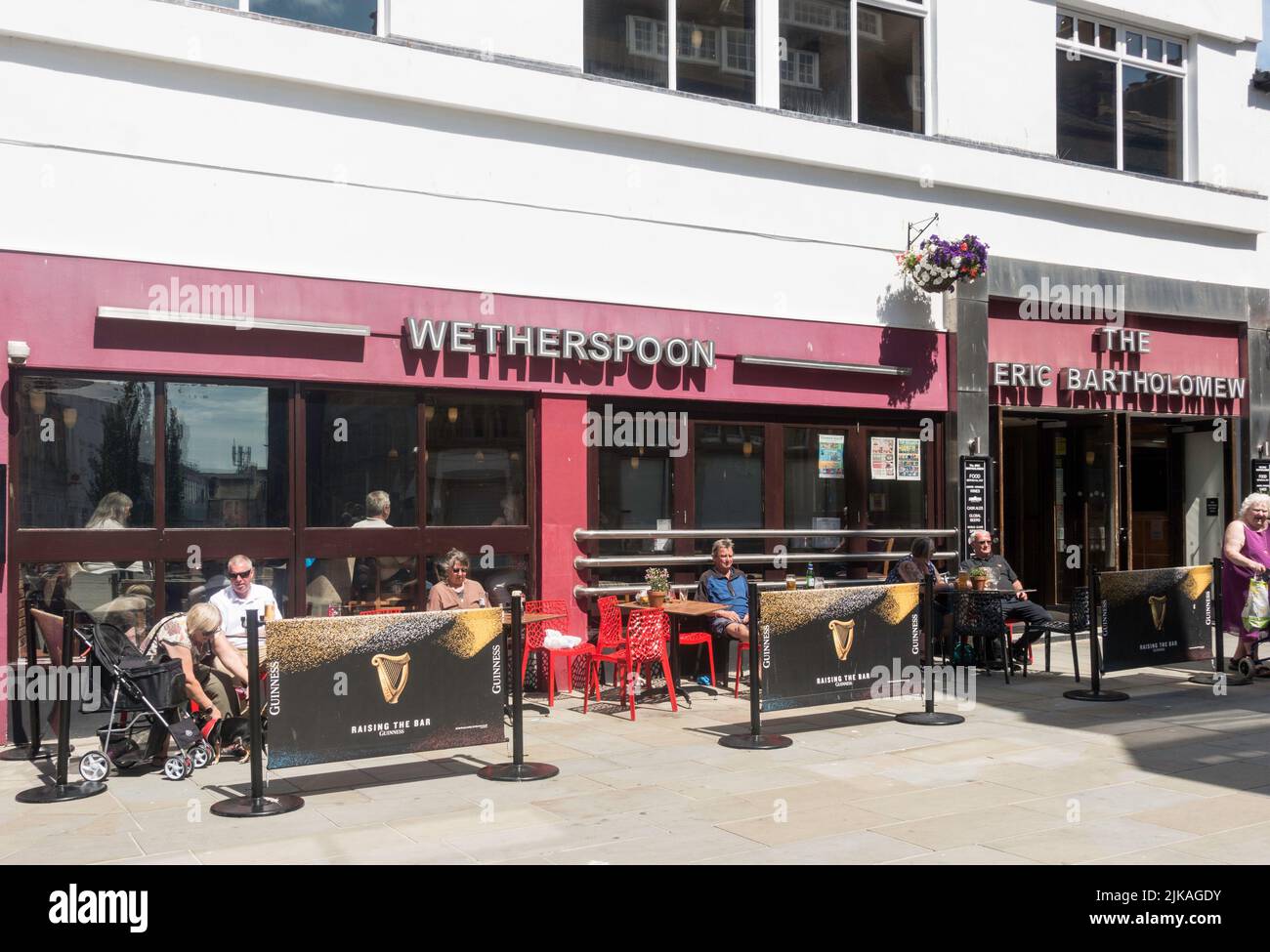 Les gens assis à l'extérieur du pub de Wetherspoon le Eric Bartholomew à Morecambe, Lancashire, Angleterre, Royaume-Uni Banque D'Images