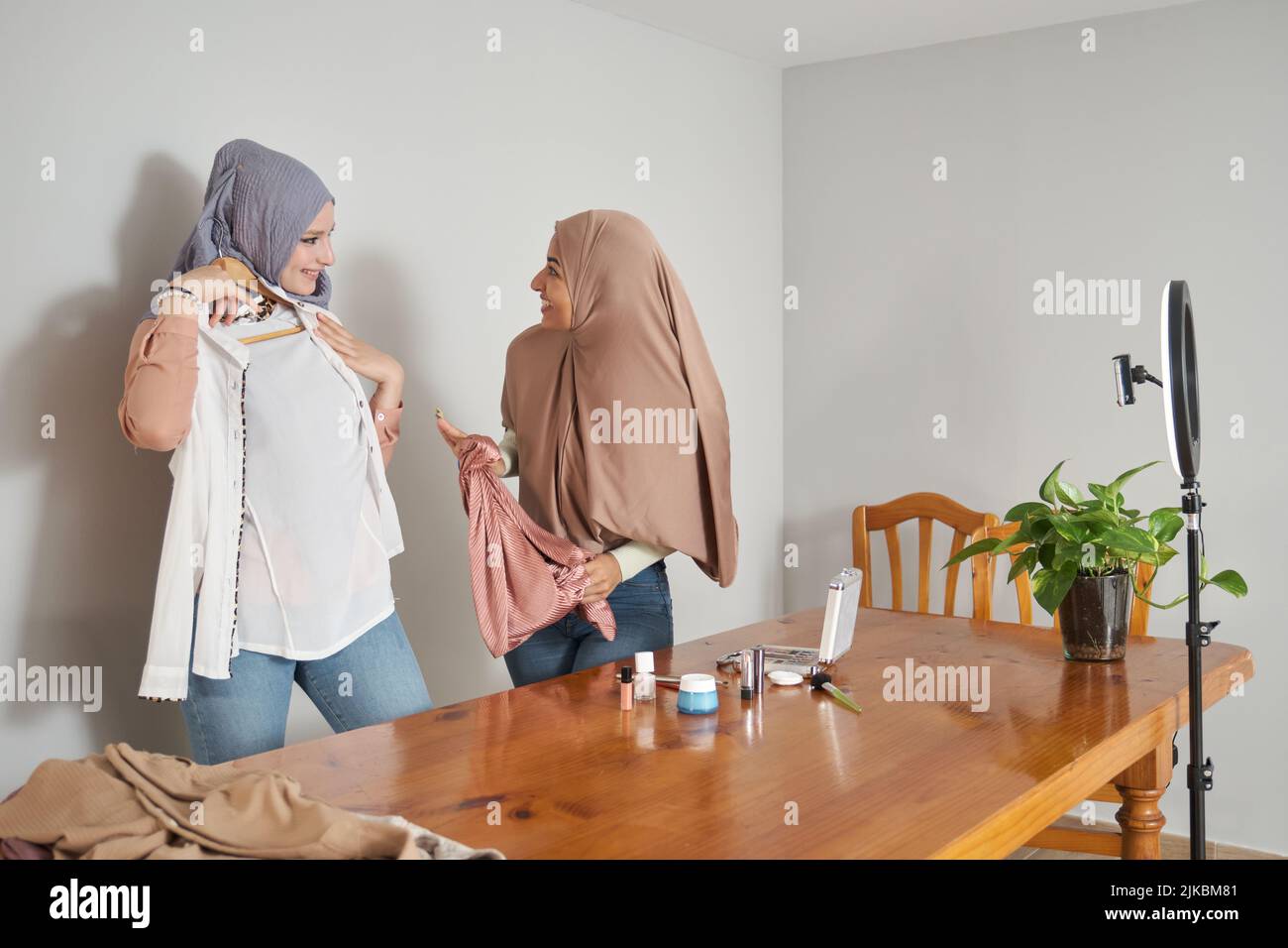De jeunes bûcherons musulmans filmant en direct un journal de mode avec des vêtements élégants. Banque D'Images