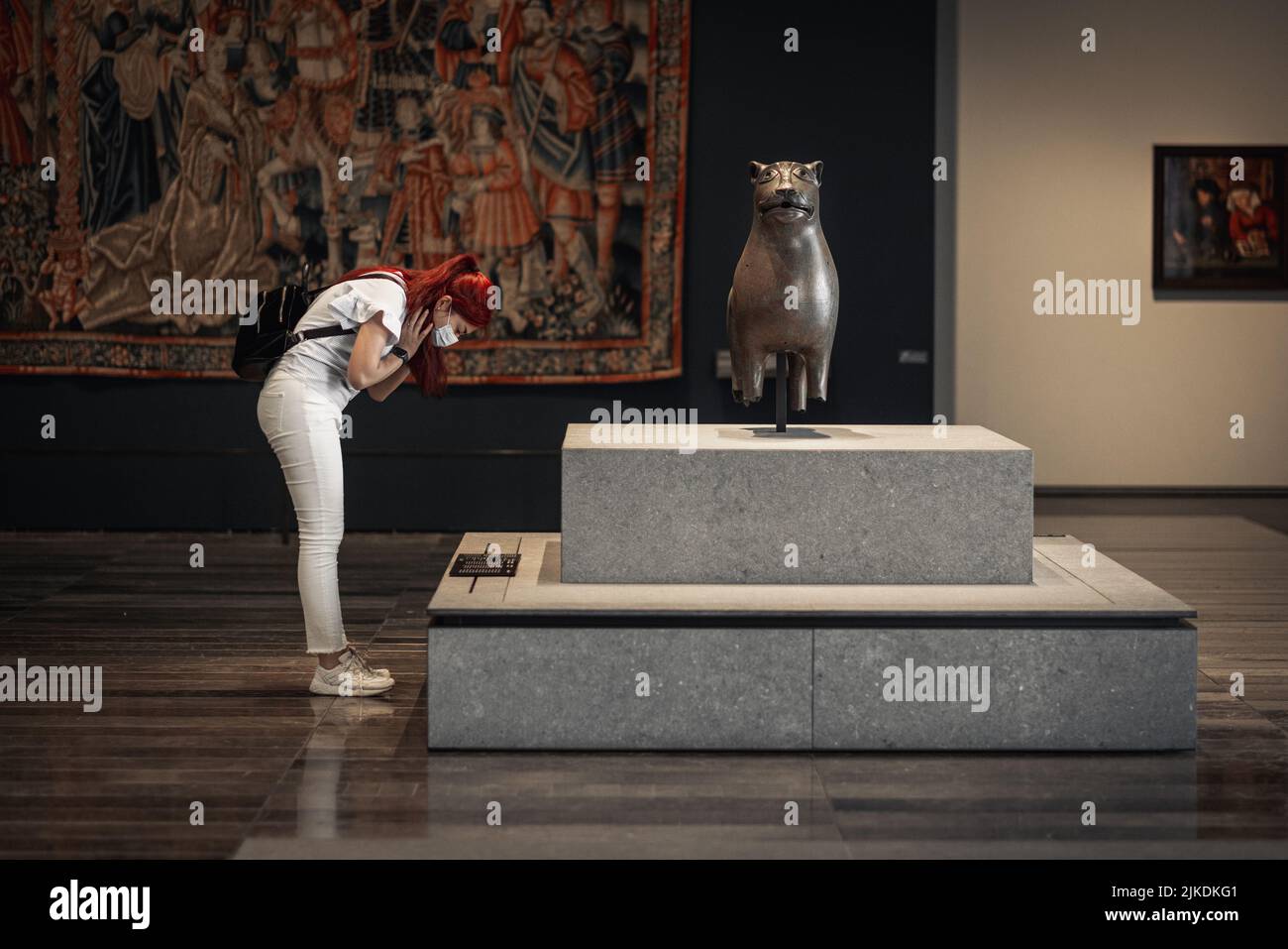 Une femme lisant la description d'une sculpture au musée du Louvre Abu Dhabi, Émirats arabes Unis Banque D'Images