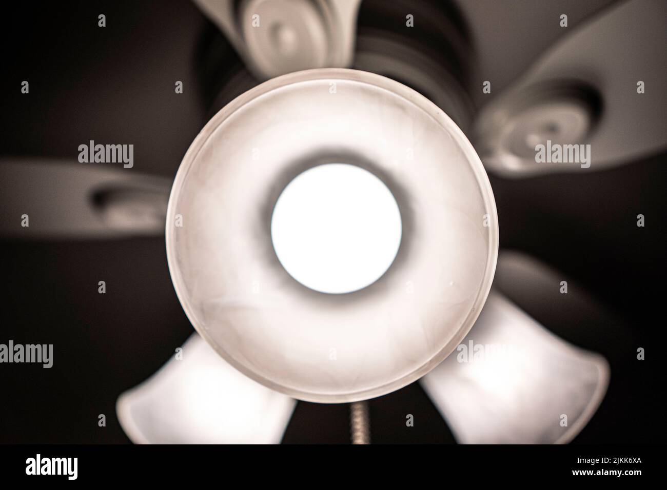 A selective focus shot of a central light of a ceiling fan Banque D'Images
