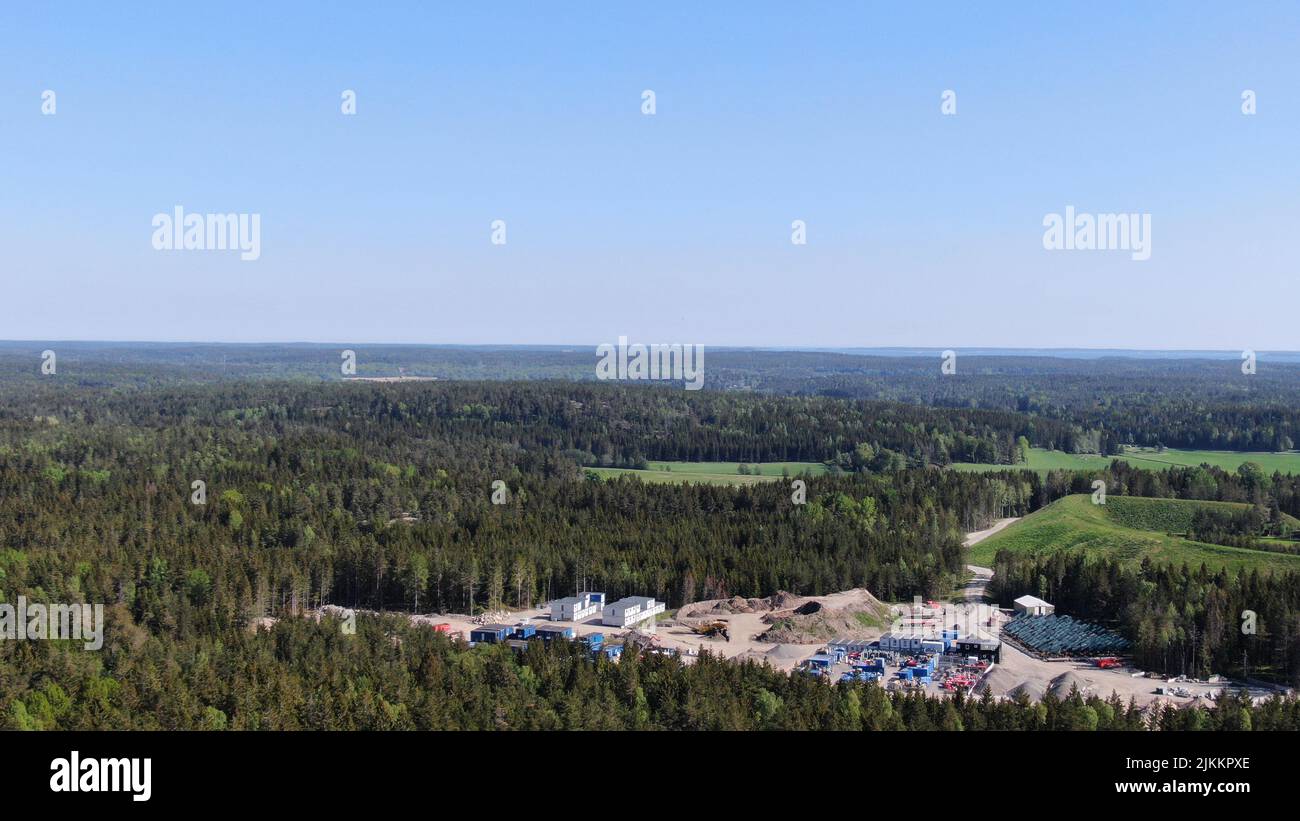 Une vue aérienne d'une zone de construction au milieu d'une forêt luxuriante avec des sapins Banque D'Images