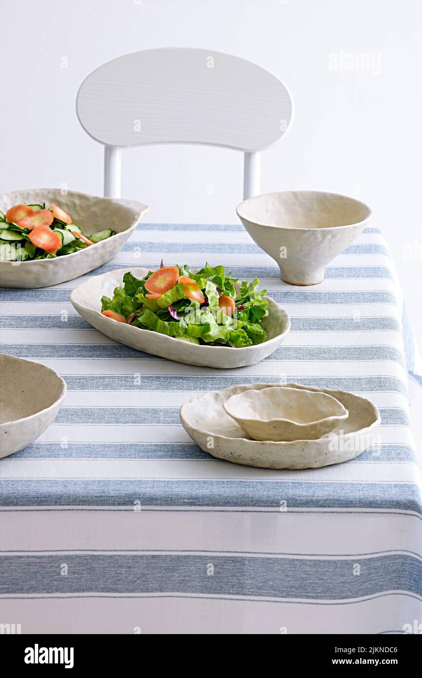 Deux portions de salade de légumes frais et savoureuses sur la table avec vaisselle élégante et minimaliste Banque D'Images