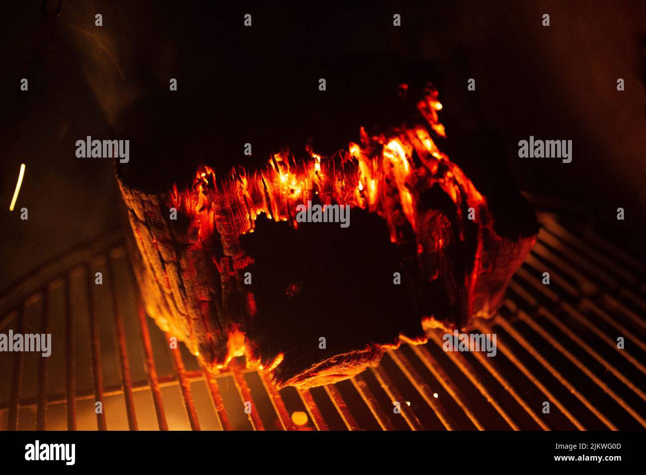 Un gros plan de charbon en feu sur un acier inoxydable Banque D'Images