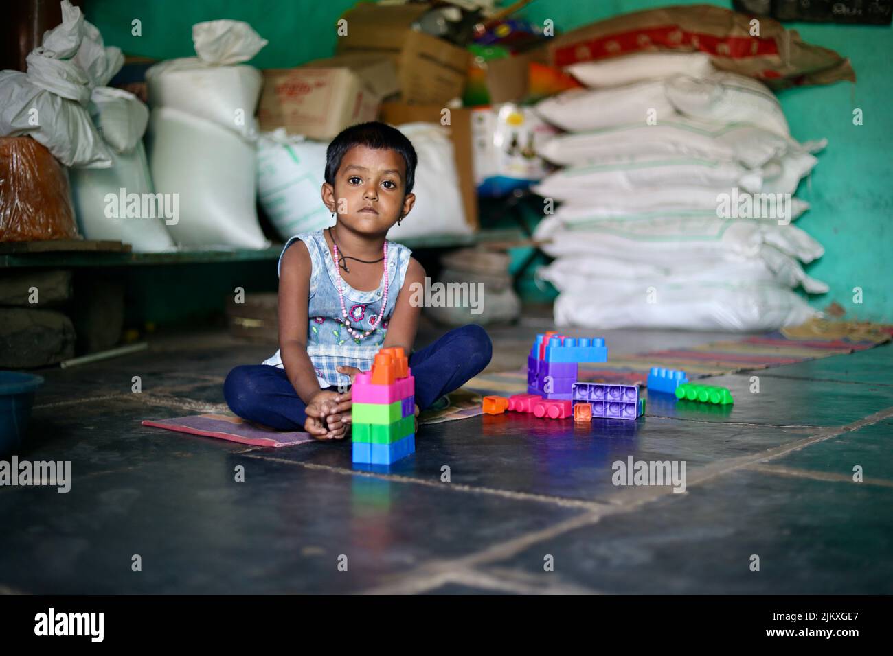 Un foyer sélectif de visage d'un petit village indien du sud jouant avec des blocs de construction dans une école maternelle (également appelé Anganwadi en Inde). Banque D'Images