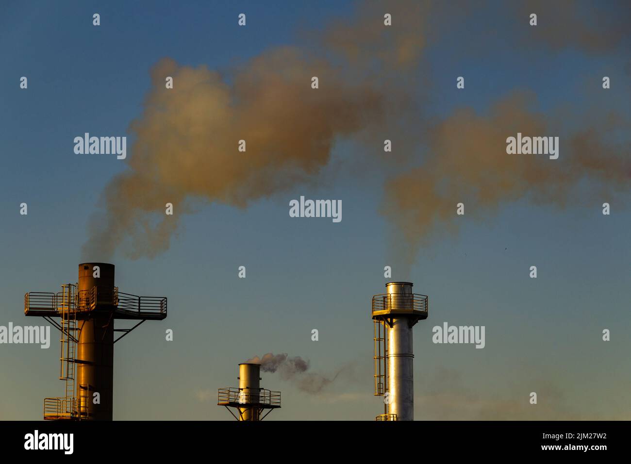 Goiania, Goiás, Brésil – 04 août 2022: Fumée provenant de trois cheminées d'une usine. Pollution de l'air par la fumée sortant de la cheminée. Banque D'Images