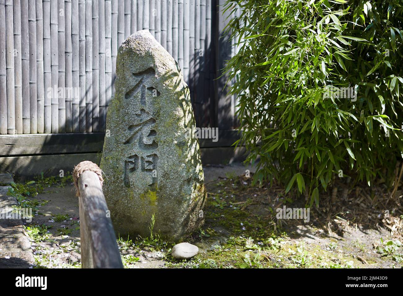 Un gros plan d'un rocher avec inscriptions dans un jardin japonais Banque D'Images