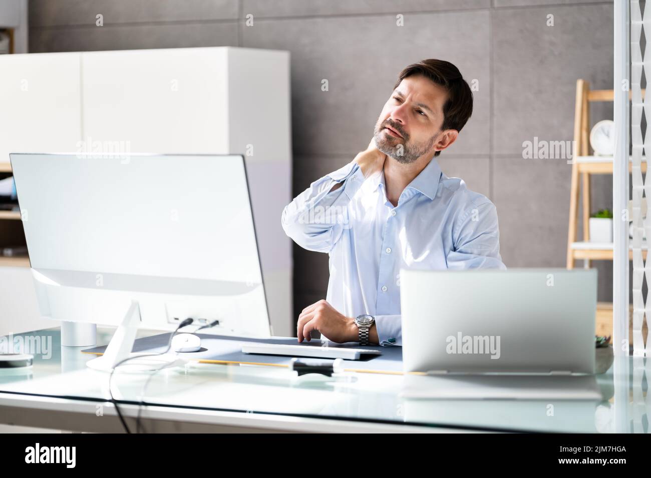 Photo de Businessman souffrant de douleur au cou Banque D'Images