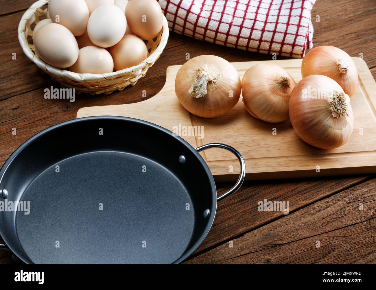 Nature morte avec oignons et oeufs de caille sur une table de cuisine Banque D'Images