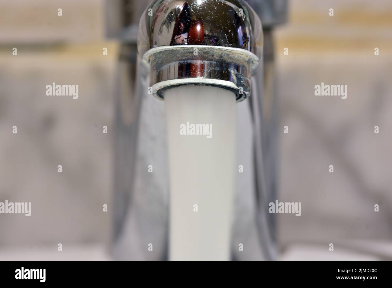 Chorro de agua cayendo de un grifo de un lavabo Banque D'Images