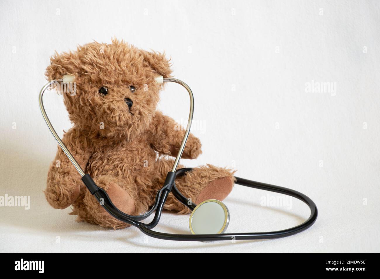 ours en peluche brun m stéthoscope sur fond isolé, pédiatrie, médecin d'enfant, médecine et science Banque D'Images