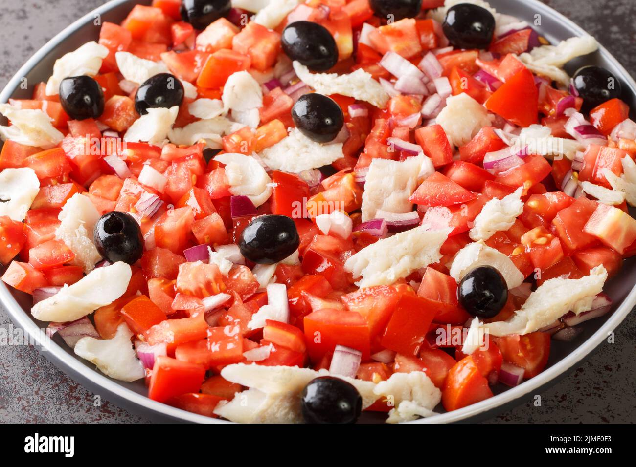 Esqueixada salade de morue une recette typique de la gastronomie catalane gros plan dans une assiette sur la table. Horizontale Banque D'Images