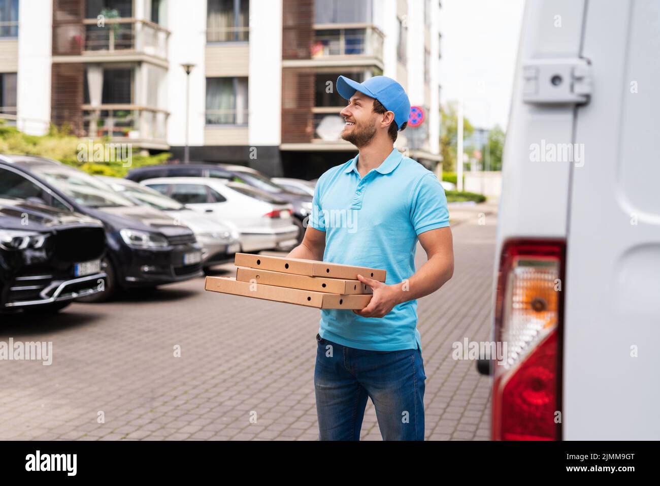 Livraison de pizza par coursier en attente d'un client Banque D'Images