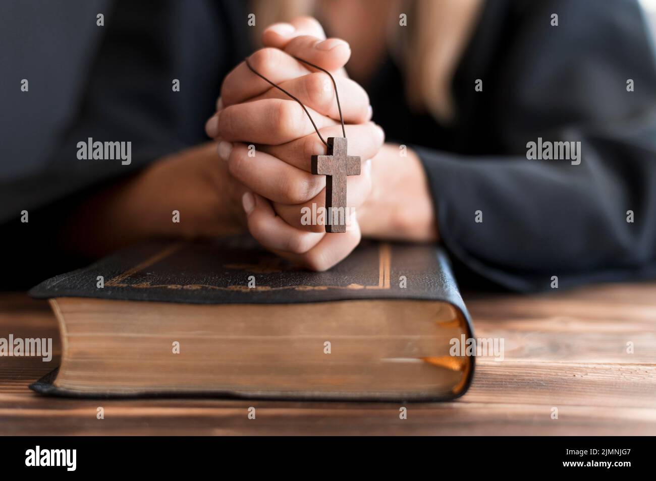 Personne priant avec la croix Saint livre Banque D'Images