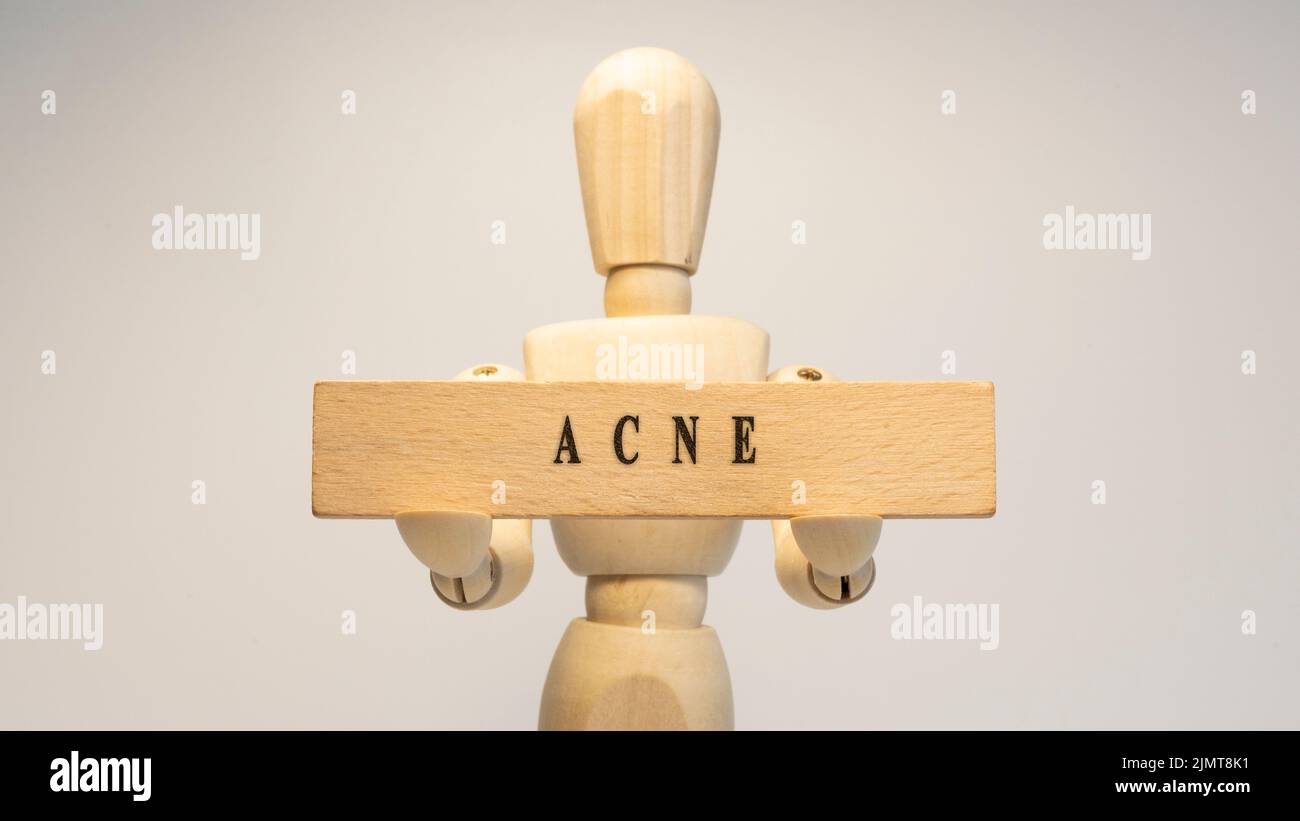Maladie d'acné écrite sur la surface en bois. Concept de santé Banque D'Images