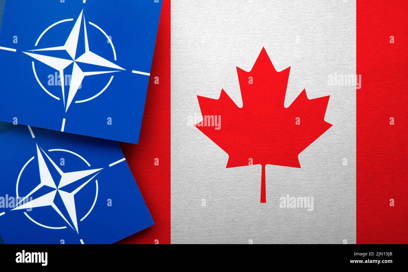 LONDRES, Royaume-Uni - août 2022 : logo de l'Alliance militaire de l'Organisation du Traité de l'Atlantique Nord de l'OTAN sur un drapeau du Canada Banque D'Images
