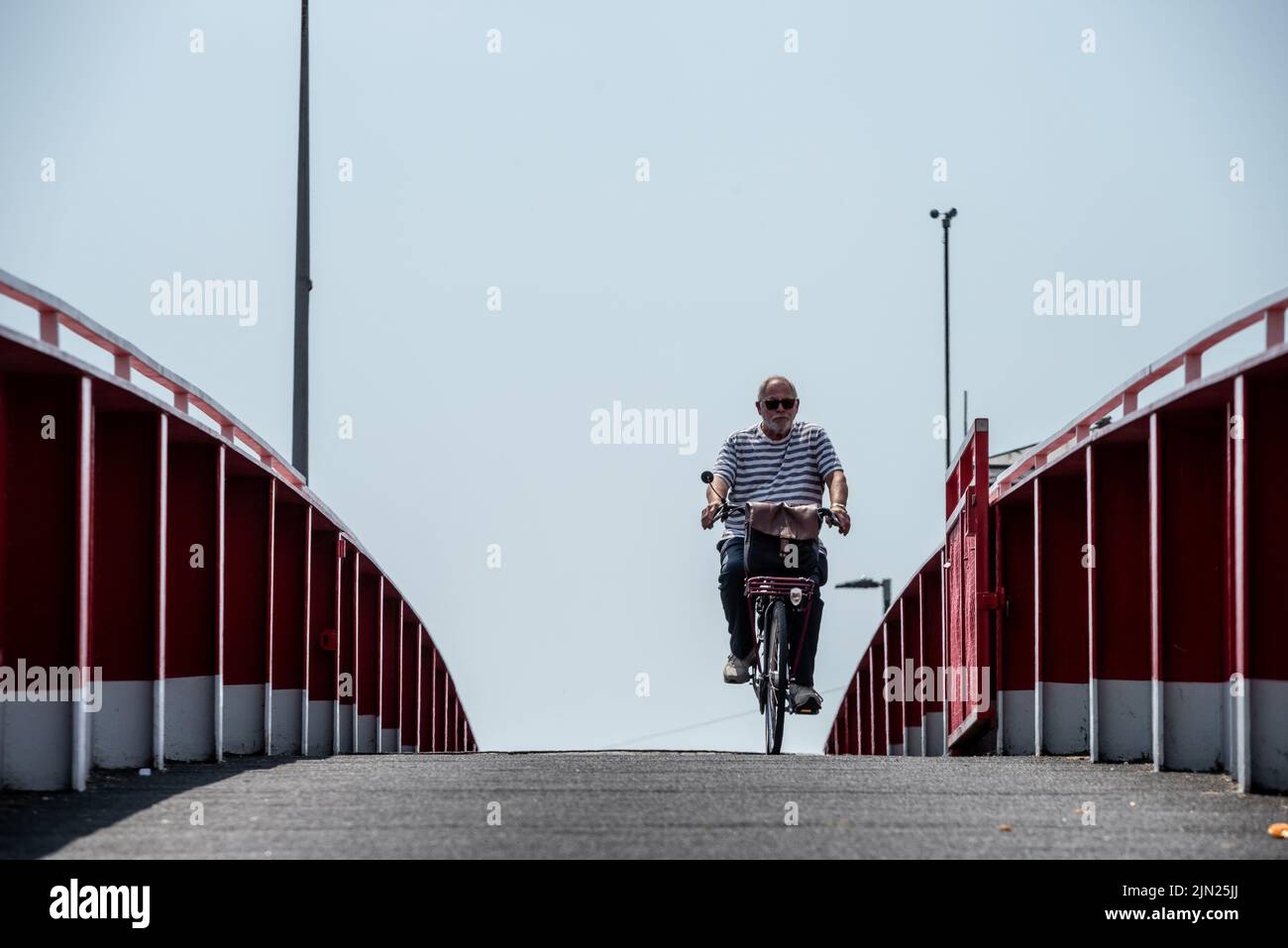 Littlehampton, 21 juillet 2022 : un cycliste qui traverse la passerelle du ferry, également connue sous le nom de pont rouge Banque D'Images