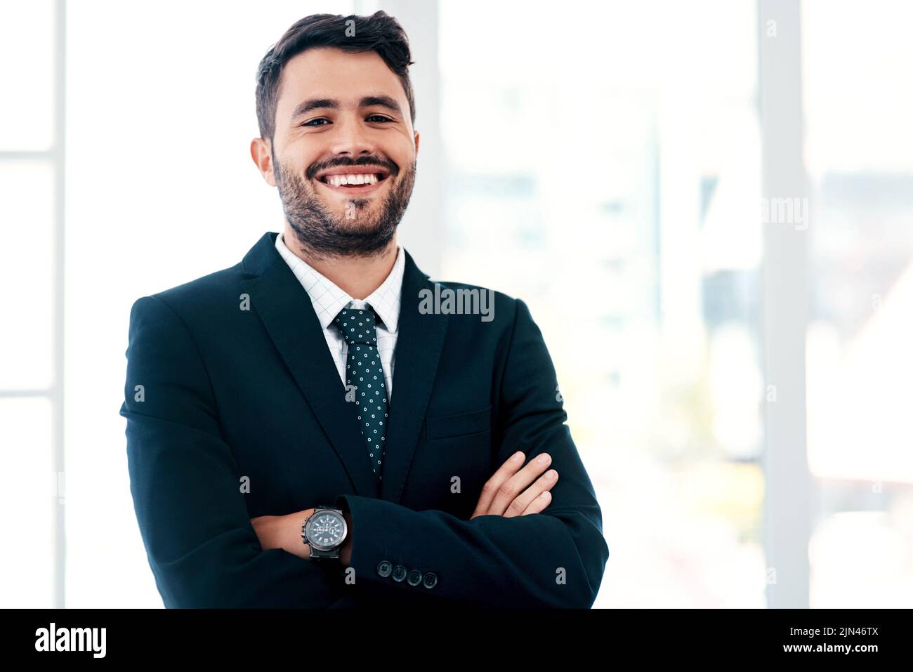 Les affaires sont tout au sujet de la façon dont vous jouez vos cartes. Portrait court d'un beau jeune homme d'affaires souriant debout avec ses bras croisés dans un Banque D'Images