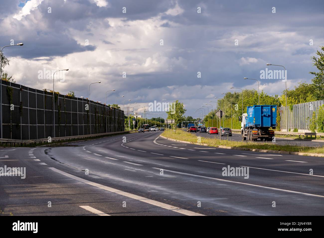 Une route avec des voitures de conduite et un camion avec une grande barrière à Poznan Banque D'Images