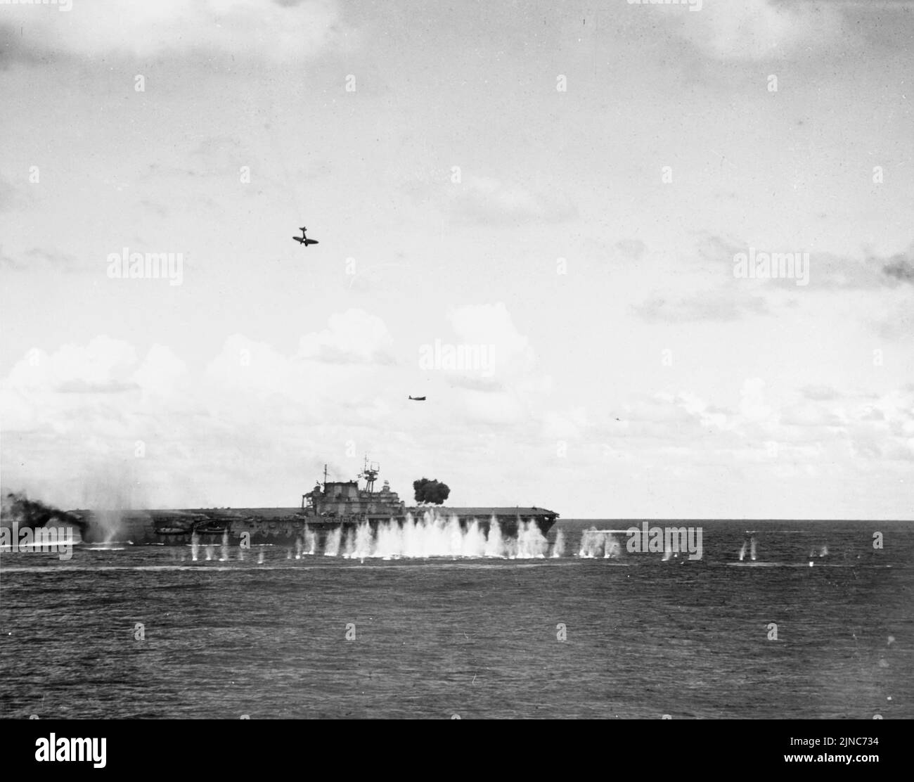 Un bombardier japonais endommagé (en haut à gauche) plonge vers le porte-avions USS Hornet de la Marine américaine pendant la bataille de Santa Cruz, le 26 octobre 1942. Banque D'Images