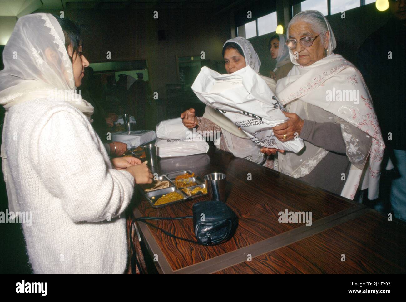 Sikh Funeral (Antam Sanskaar) vêtements donnés aux filles de la victime - femmes portant le traditionnel blanc Banque D'Images