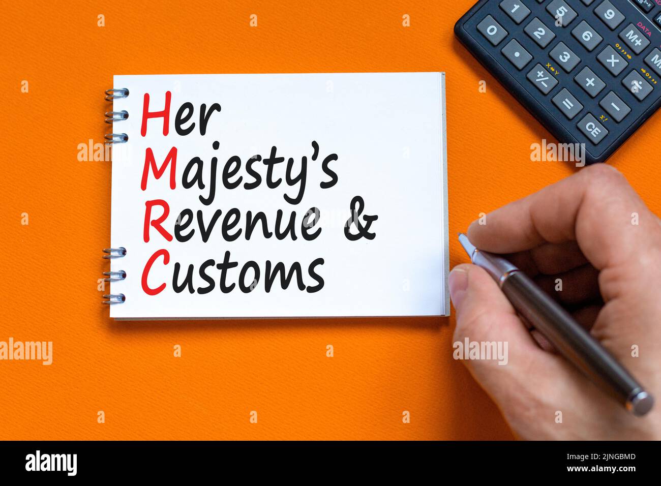 HMRC son symbole de recettes et de douanes majestys. Mots de concept HMRC son majestys chiffre d'affaires et coutumes sur note blanche sur fond orange magnifique. Buline Banque D'Images